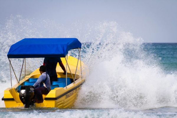 yellow boat on the ocean waves adventure